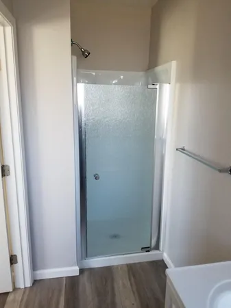 a bathroom with a glass shower door