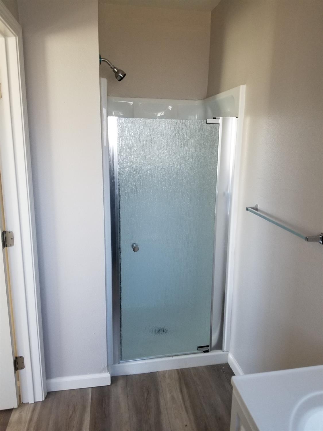618 J Street Modesto, CA 95354 - Photo 9 of 38 a bathroom with a glass shower door