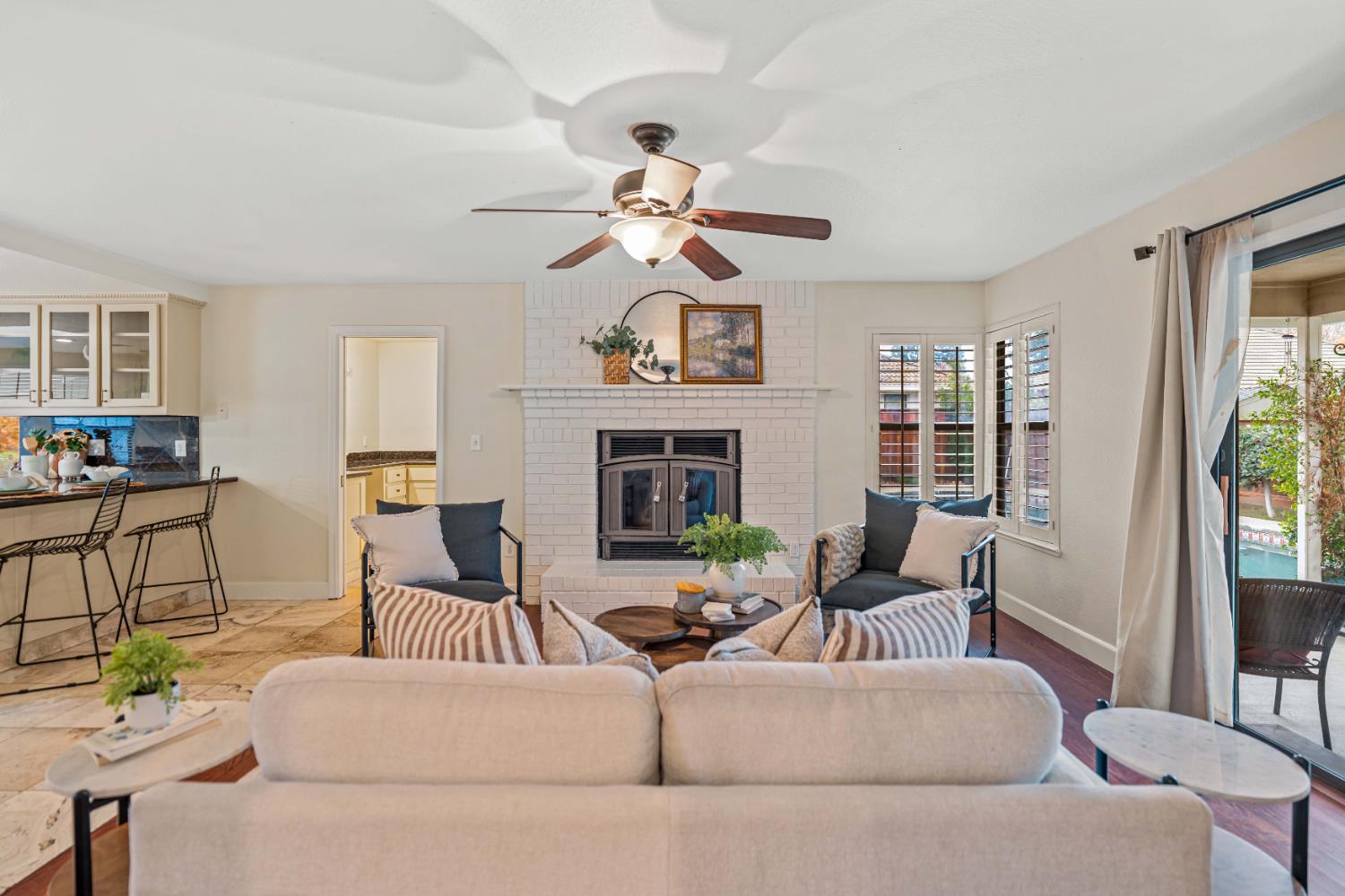 3829 Mondrian Drive Modesto, CA 95356 - Photo 12 of 37 a living room with furniture a fireplace and a window