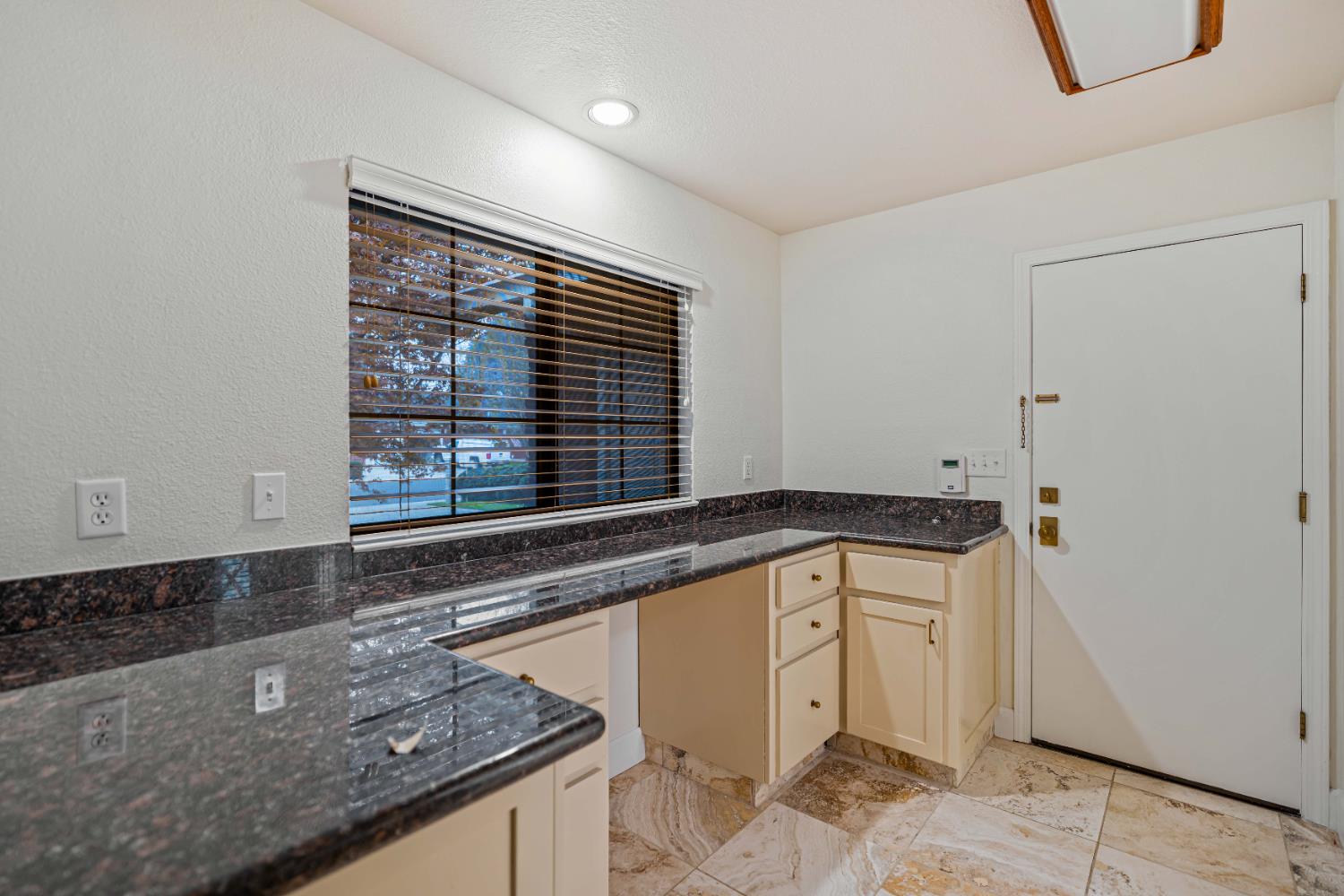 3829 Mondrian Drive Modesto, CA 95356 - Photo 14 of 37 a kitchen with granite countertop a sink and a stove