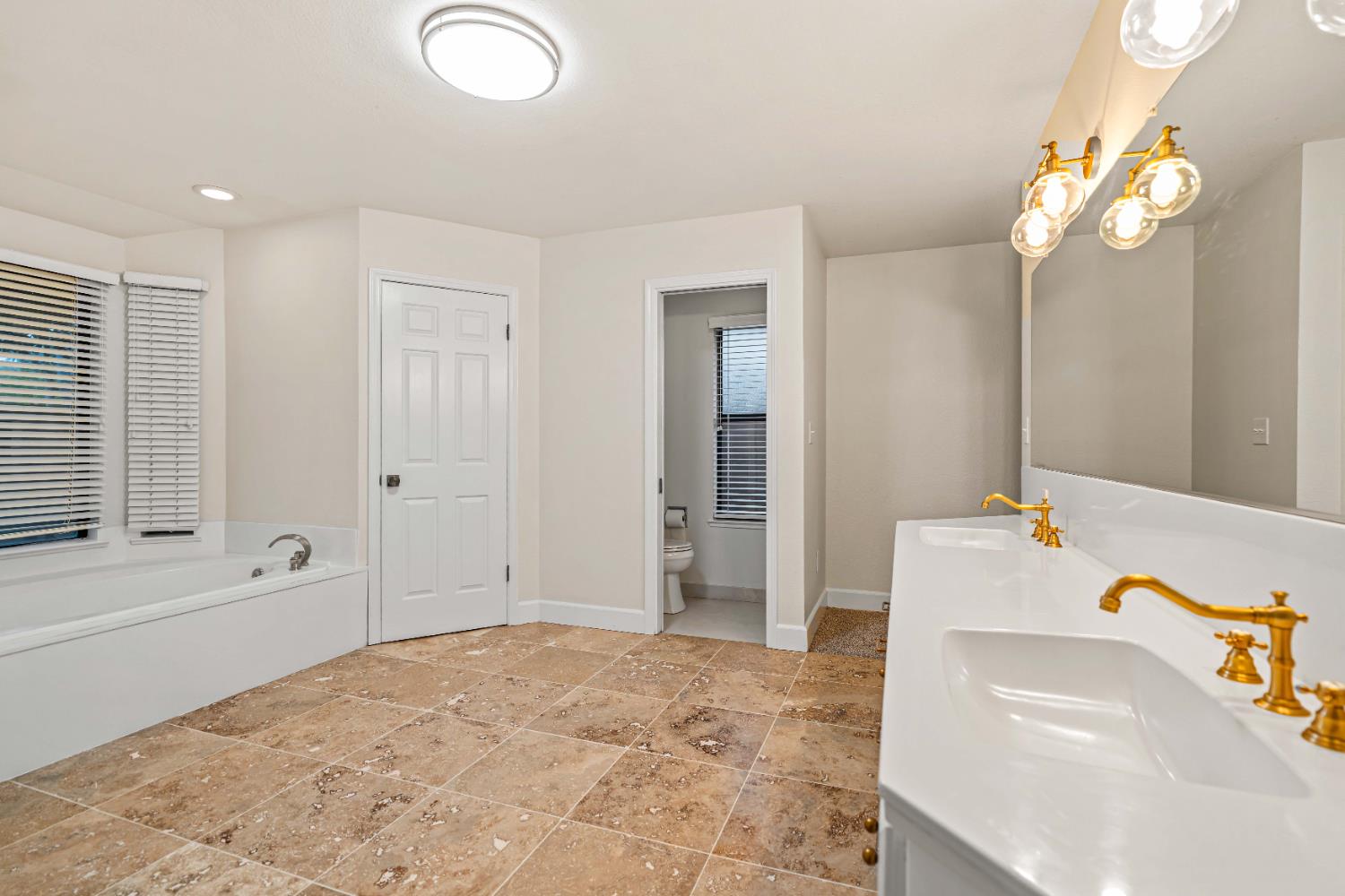 3829 Mondrian Drive Modesto, CA 95356 - Photo 19 of 37 a bathroom with a tub sink and mirror