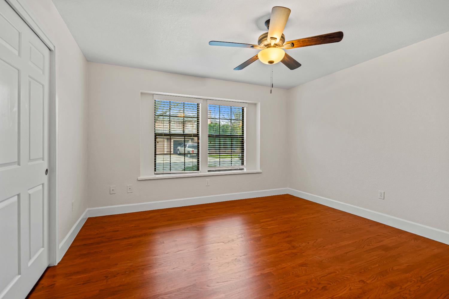 3829 Mondrian Drive Modesto, CA 95356 - Photo 24 of 37 a view of an empty room with window and wooden floor