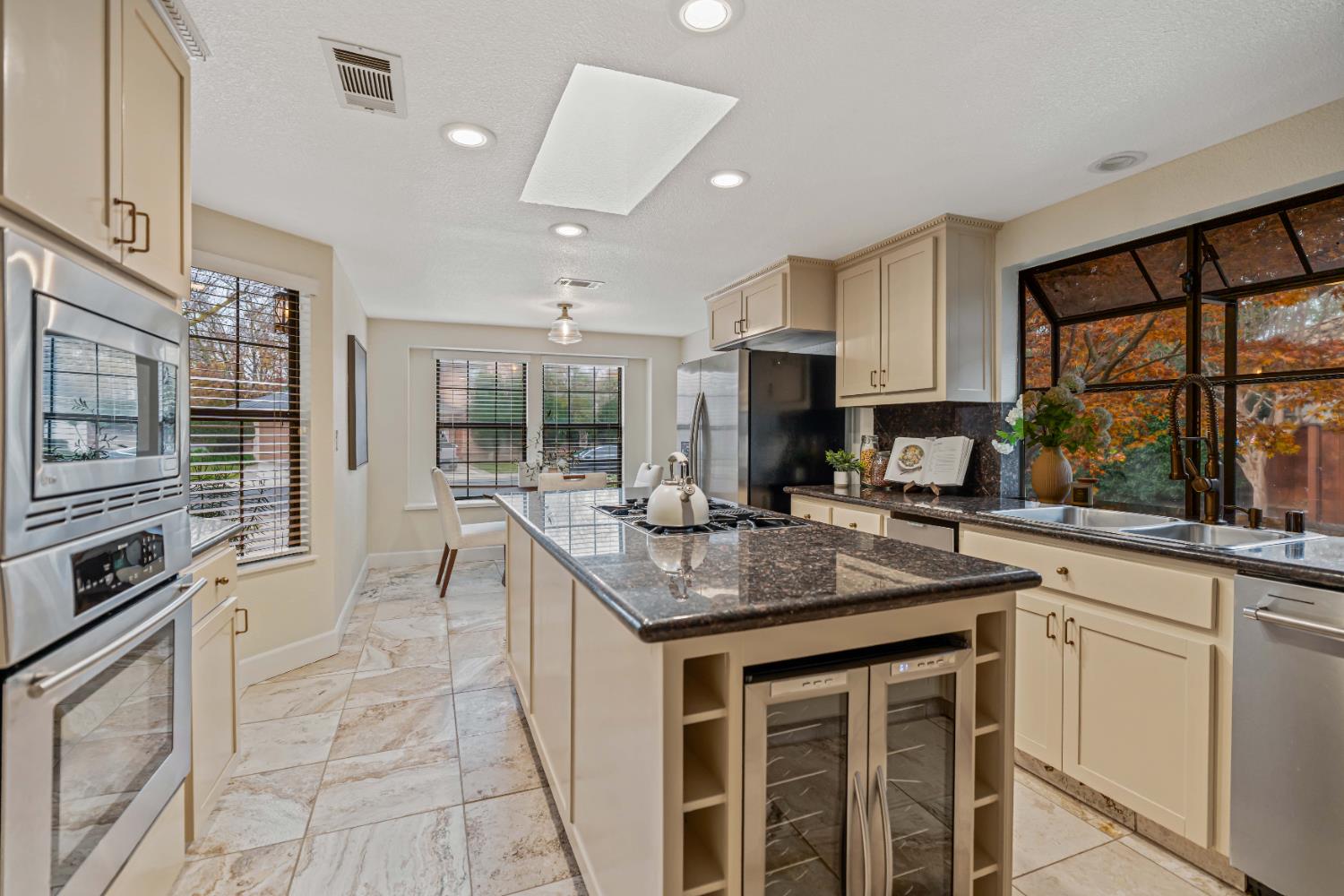 3829 Mondrian Drive Modesto, CA 95356 - Photo 8 of 37 a kitchen with stainless steel appliances granite countertop a stove a sink and a microwave