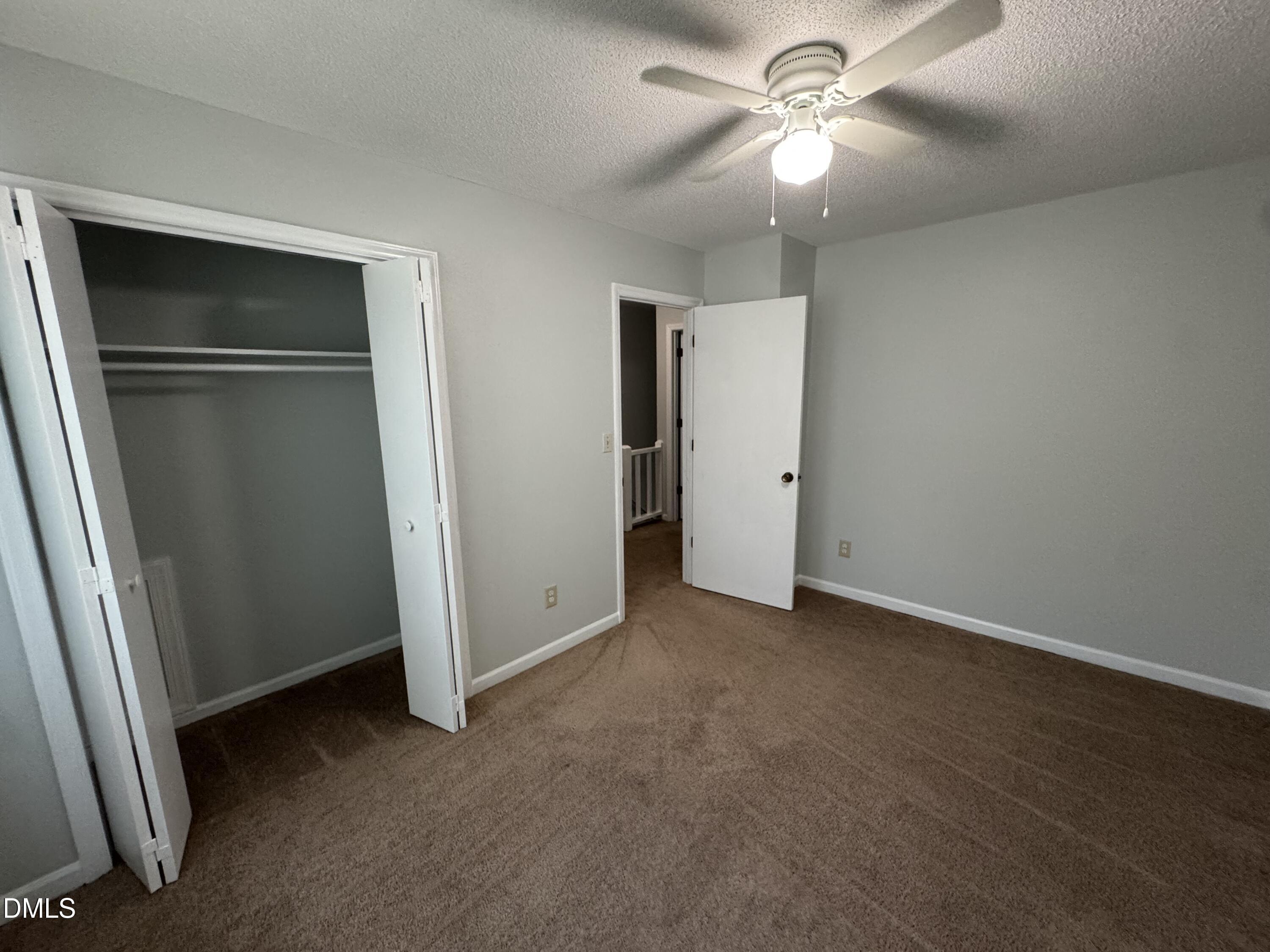 4200 Bertram Drive Raleigh, NC 27604 - Photo 10 of 16 an empty room with closet and a ceiling fan