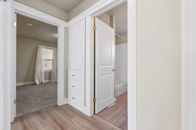 an empty room with a empty space and windows