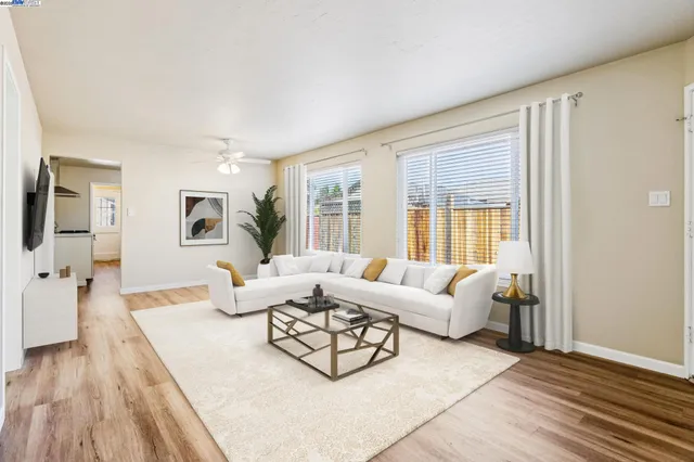 a living room with furniture and wooden floor