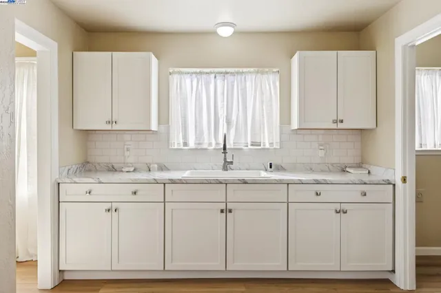 a view of cabinets with granite countertop white cabinets