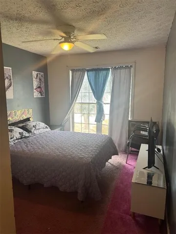 a bed sitting in a bedroom next to a window