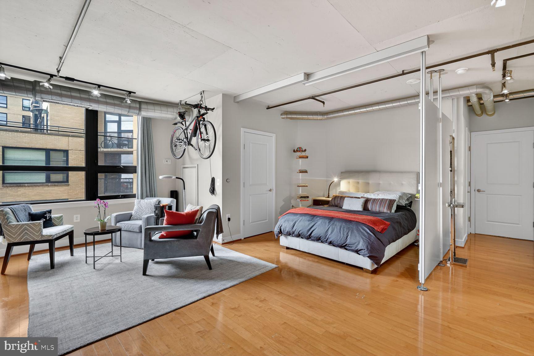 2125 14th Street Northwest, Unit 531 Washington, DC 20009 - Photo 9 of 20 a spacious bedroom with a bed and a chandelier
