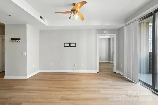 a view of empty room with wooden floor
