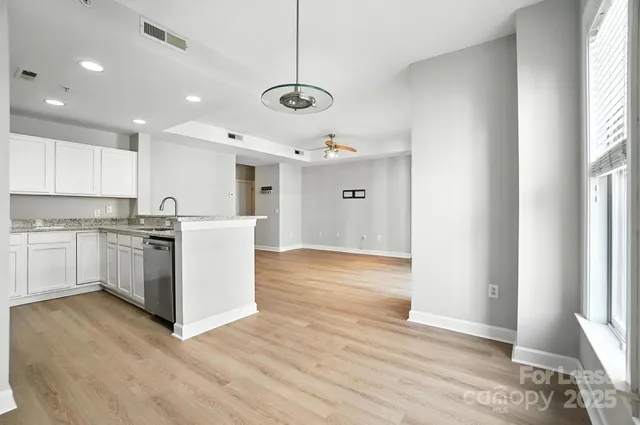 a view of a kitchen with wooden floor