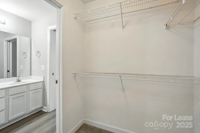 a view of a room with racks on the wall and shower