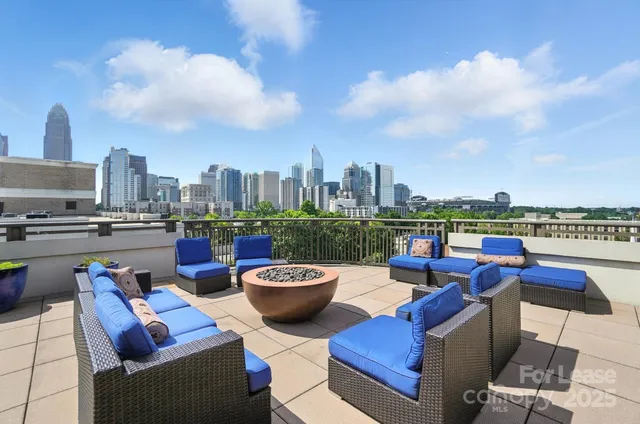 a terrace with outdoor seating city view and barbeque oven