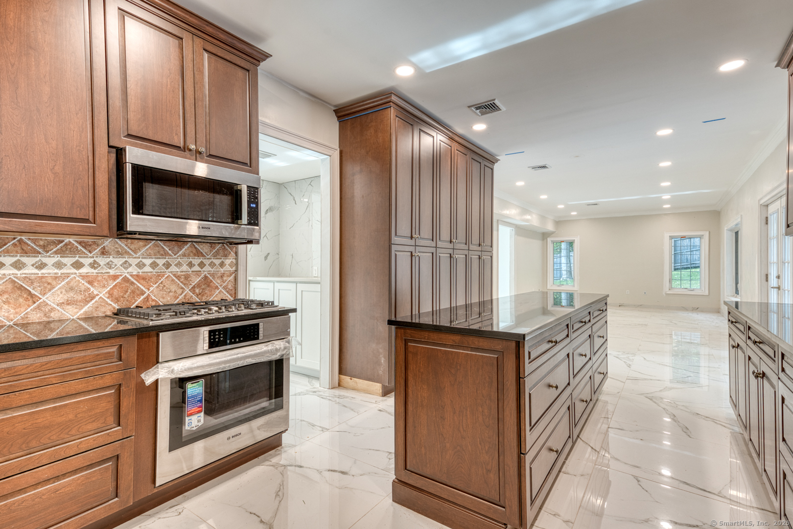 171 Oregon Road Meriden, CT 06451 - Photo 15 of 38 a kitchen with stainless steel appliances kitchen island granite countertop a stove top oven a sink and a microwave