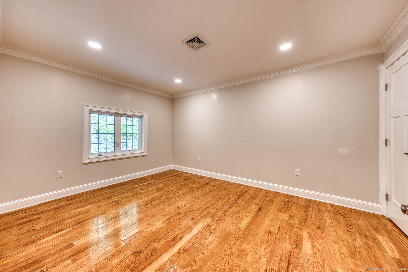 171 Oregon Road Meriden, CT 06451 - Photo 24 of 38 a view of an empty room with wooden floor and a window
