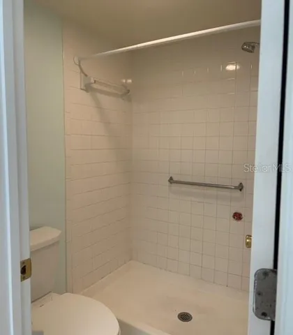 a bathroom with a shower and a toilet
