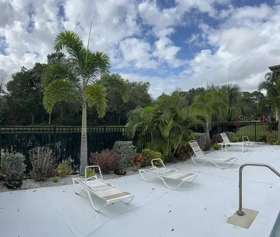 a view of a chair and table in the backyard