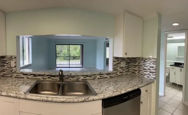 a kitchen with granite countertop a sink and a granite counter tops