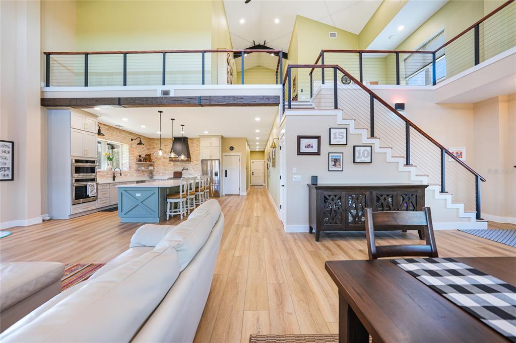 3321 Southwest Martin Lane Arcadia, FL 34266 - Photo 12 of 81 a view of a living room and kitchen with furniture wooden floor and windows
