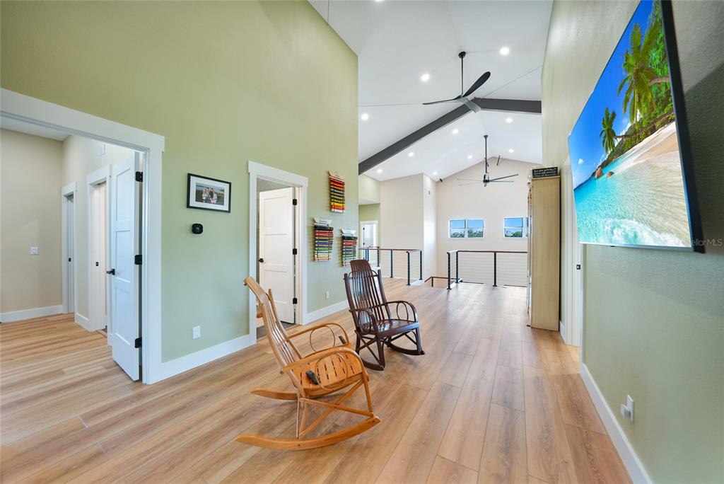 3321 Southwest Martin Lane Arcadia, FL 34266 - Photo 38 of 81 a view of a hallway with wooden floor and furniture