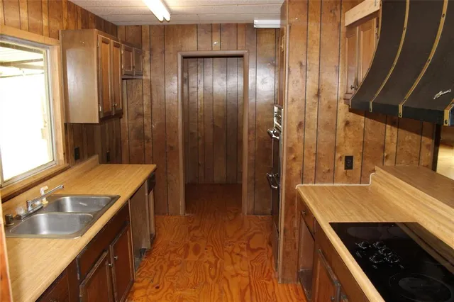 a kitchen with a sink stove and refrigerator