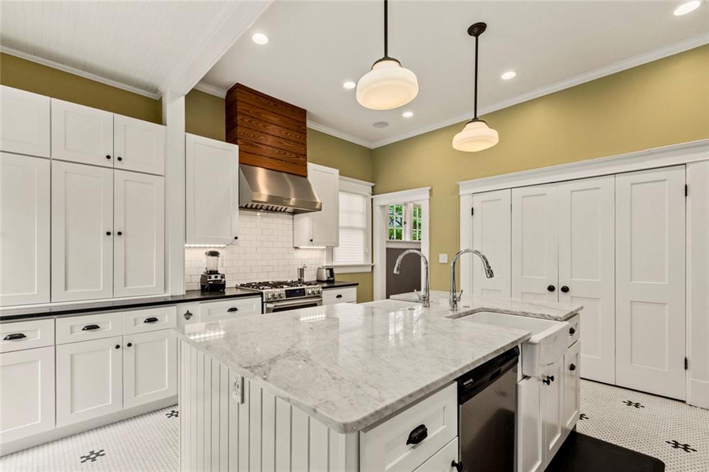 976 Adair Avenue Northeast Atlanta, GA 30306 - Photo 27 of 38 a kitchen with granite countertop a sink a stove and cabinets