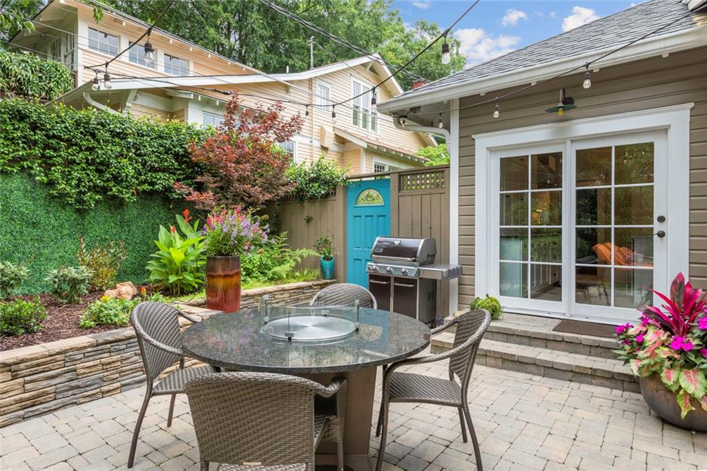 976 Adair Avenue Northeast Atlanta, GA 30306 - Photo 34 of 38 a view of a patio with table and chairs and potted plants
