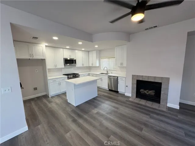a kitchen with a refrigerator and a stove top oven