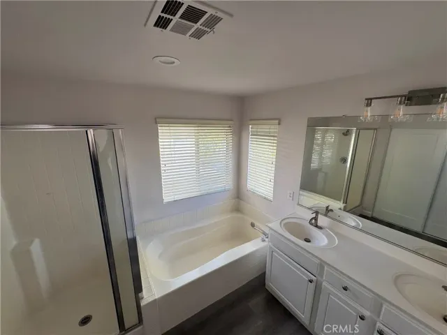 a bathroom with a tub sink and mirror