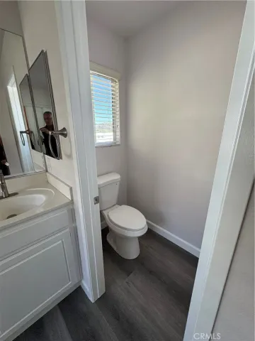 a bathroom with a toilet sink and a mirror