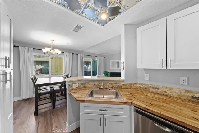 a kitchen with granite countertop sink stove and cabinets