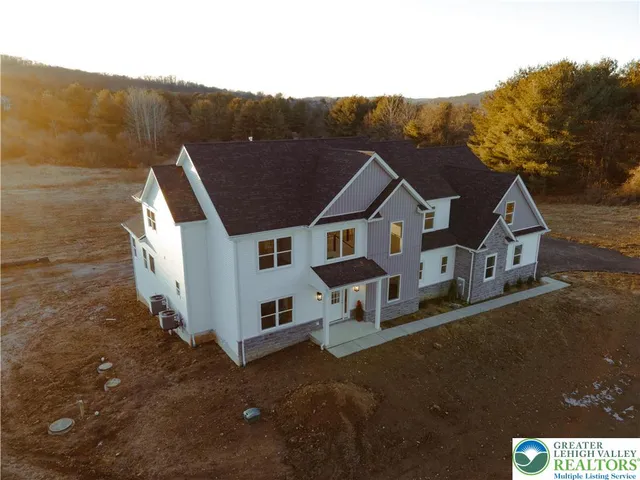 a view of house with a yard and balcony