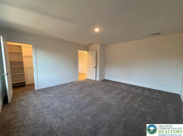 a view of an empty room and a window