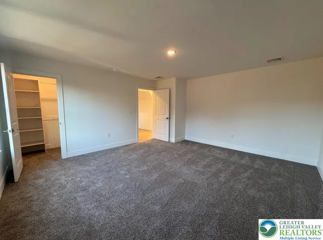 a view of an empty room and a window