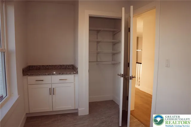 a kitchen with a refrigerator and cabinets