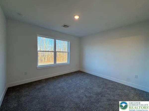 an empty room with a empty space and windows