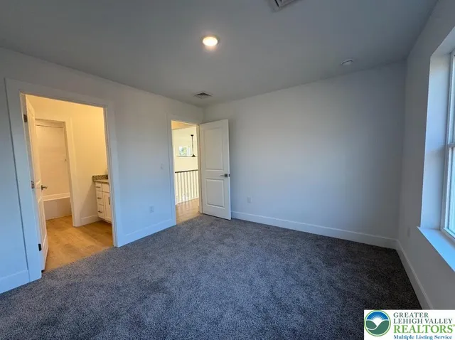 an empty room with closet and wooden door