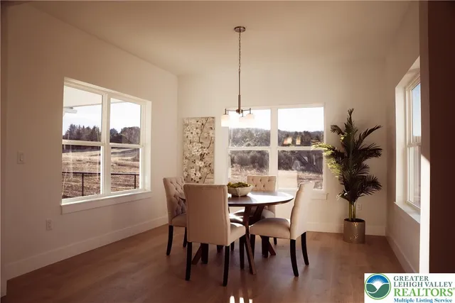 a view of a dining room with furniture window and wooden floor