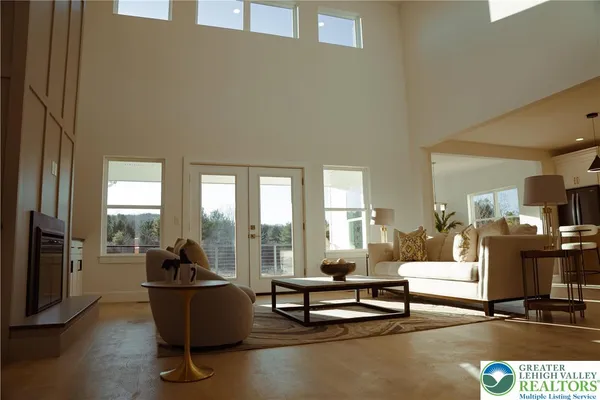 a living room with furniture and a floor to ceiling window