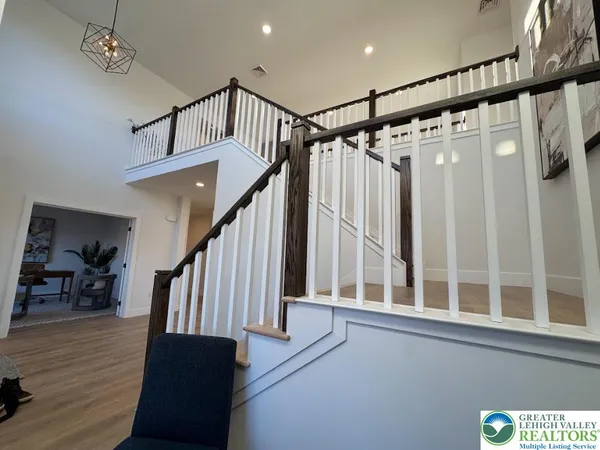 a view of entryway with wooden floor and stairs