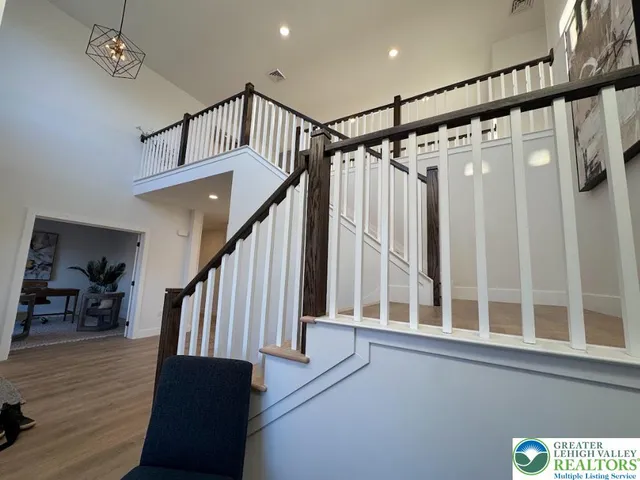 a view of entryway with wooden floor and stairs