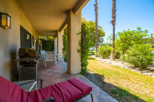 a view of an chairs and table in the patio