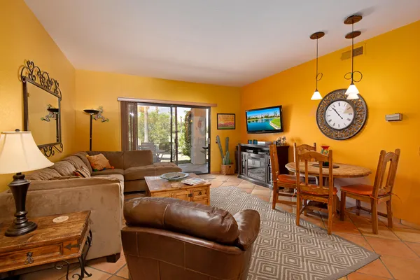 a living room with furniture a large window and a clock