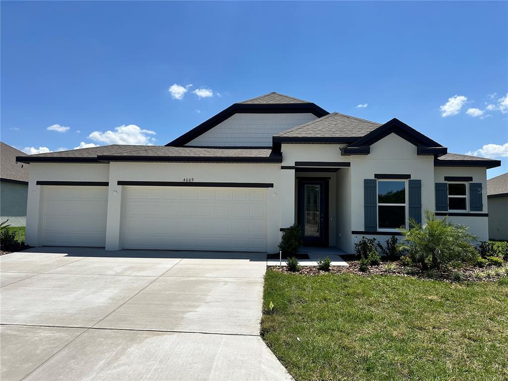 4009 Maggie Loop Lakeland, FL 33813 - Photo 1 of 1 a front view of a house with a yard