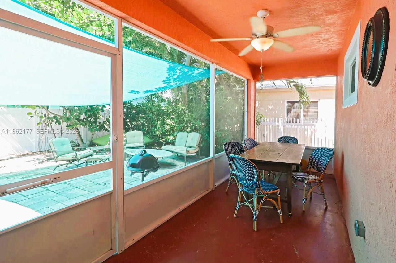 29 Bass Avenue Key Largo, FL 33037 - Photo 5 of 38 a dining room with furniture and a floor to ceiling window