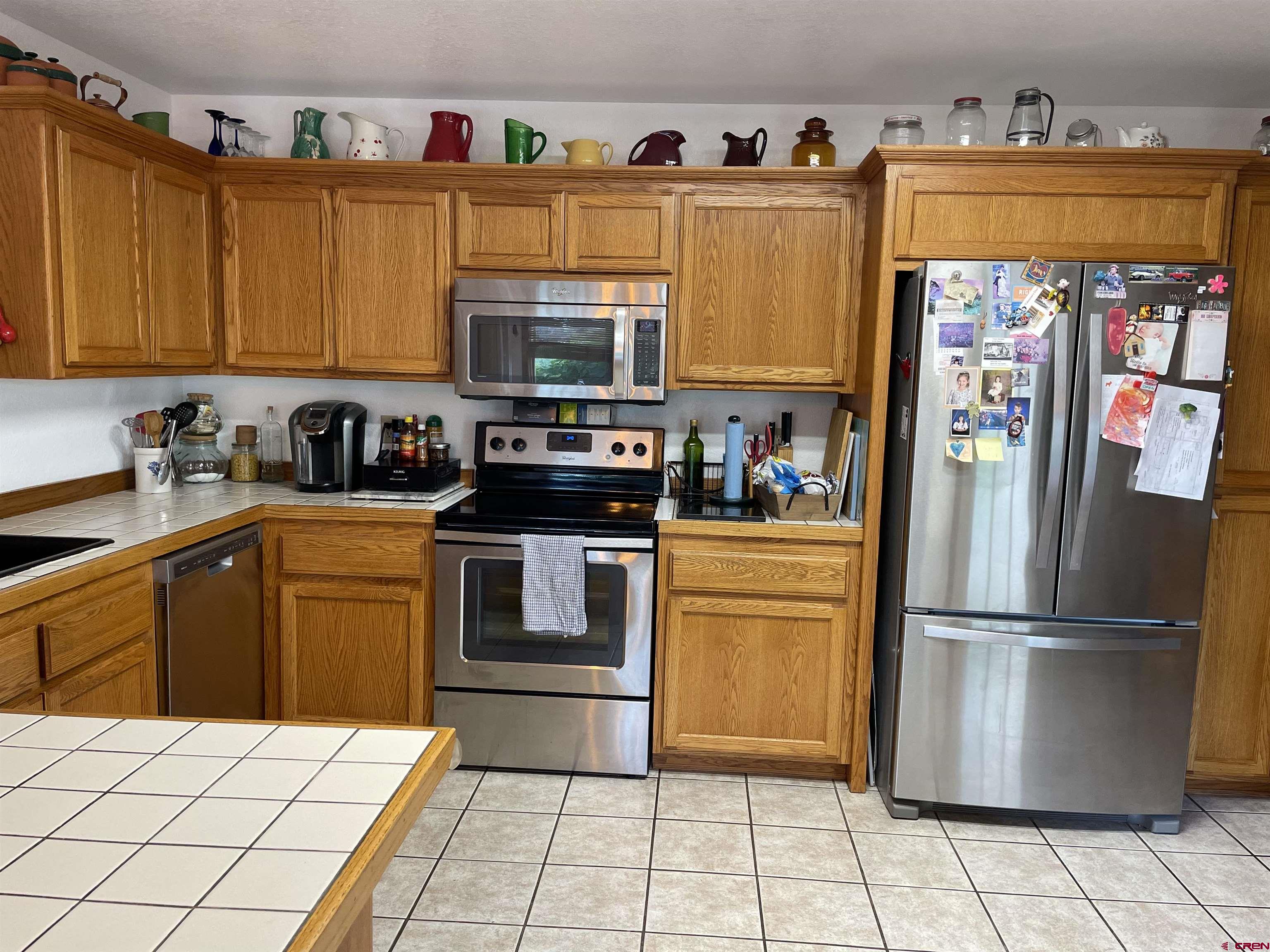 14755 6215th Road Montrose, CO 81403 - Photo 11 of 34 a kitchen with stainless steel appliances granite countertop a refrigerator sink and cabinets