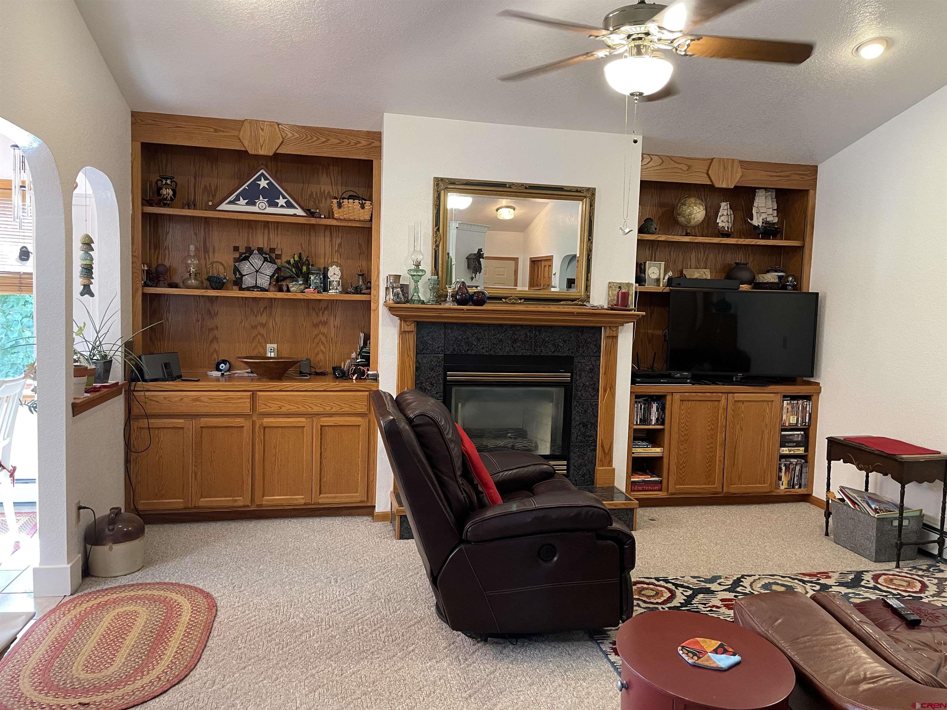 14755 6215th Road Montrose, CO 81403 - Photo 14 of 34 a living room with furniture and a flat screen tv