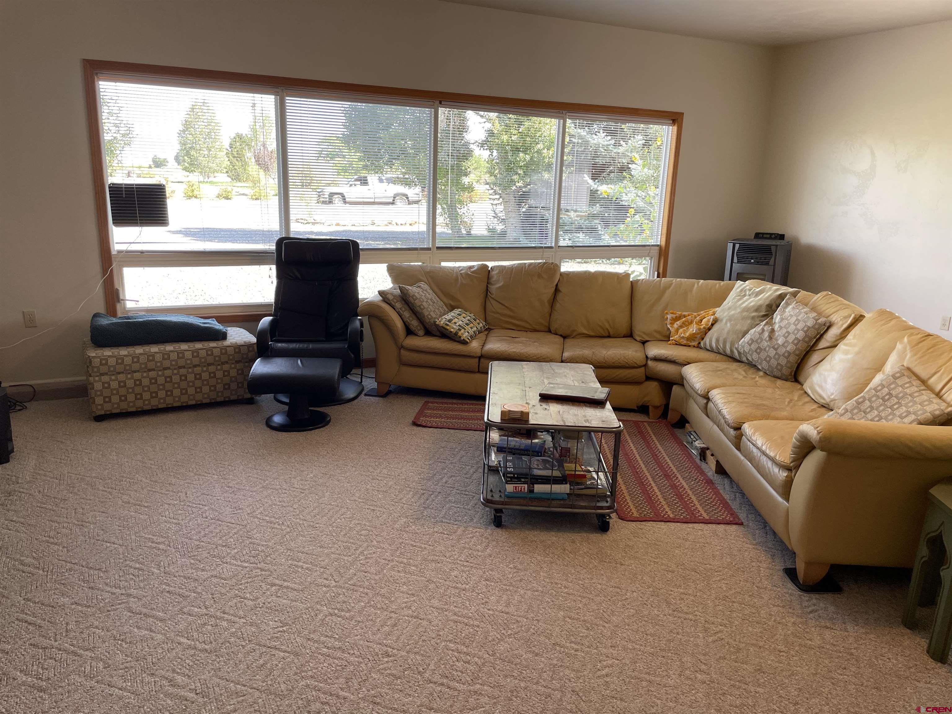 14755 6215th Road Montrose, CO 81403 - Photo 18 of 34 a living room with furniture and a large window