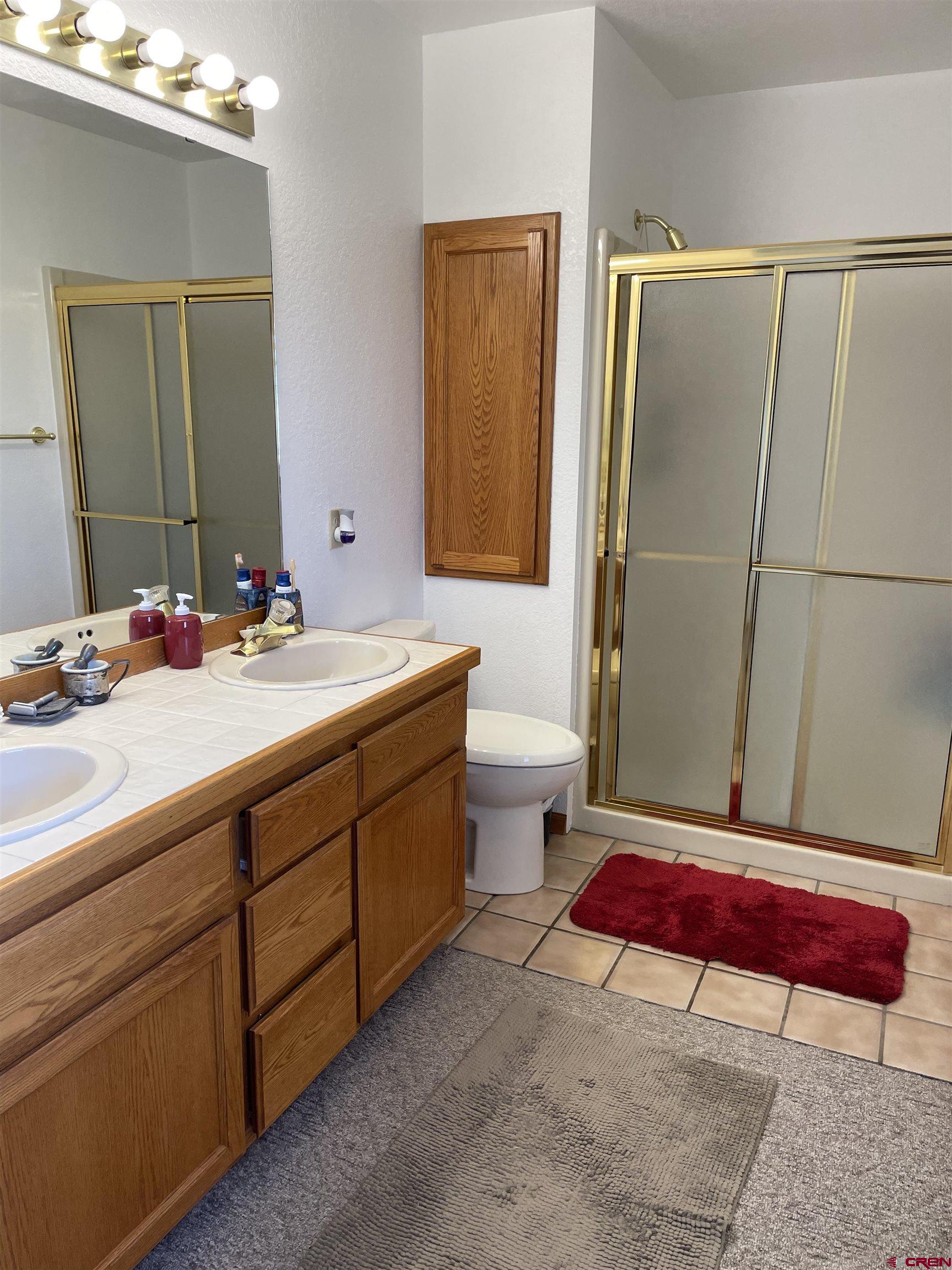 14755 6215th Road Montrose, CO 81403 - Photo 23 of 34 a bathroom with a sink and a mirror