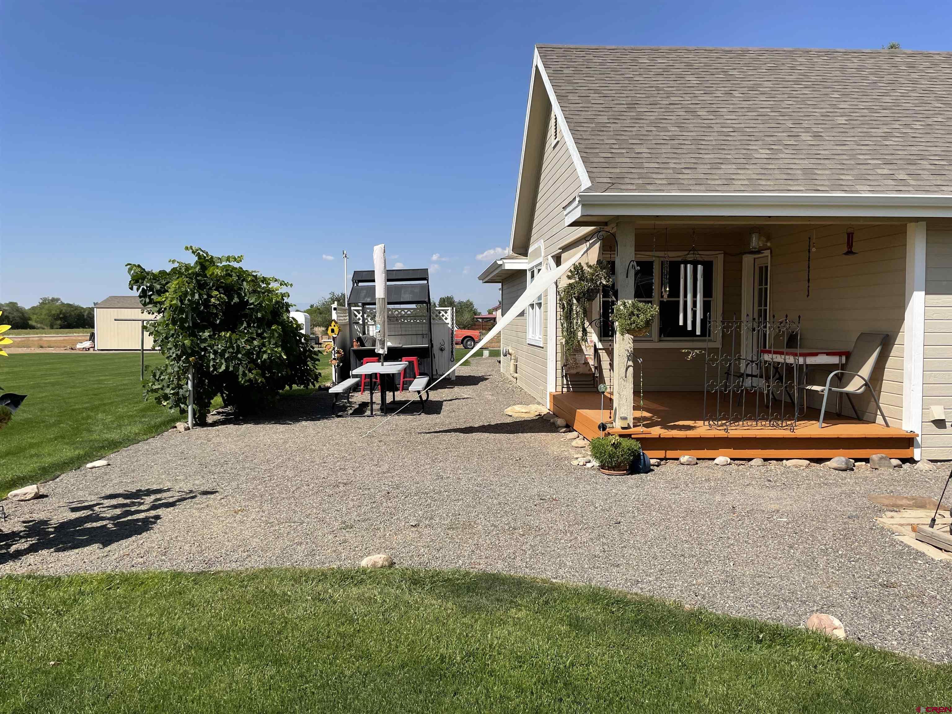 14755 6215th Road Montrose, CO 81403 - Photo 34 of 34 a view of a house with backyard porch and sitting area